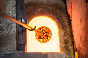 Superheated blown glass piece coming out of a furnace in Murano, Italy