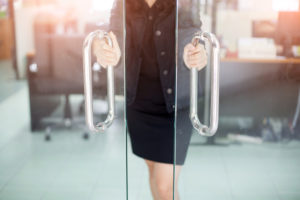 woman's hands opening glass doors