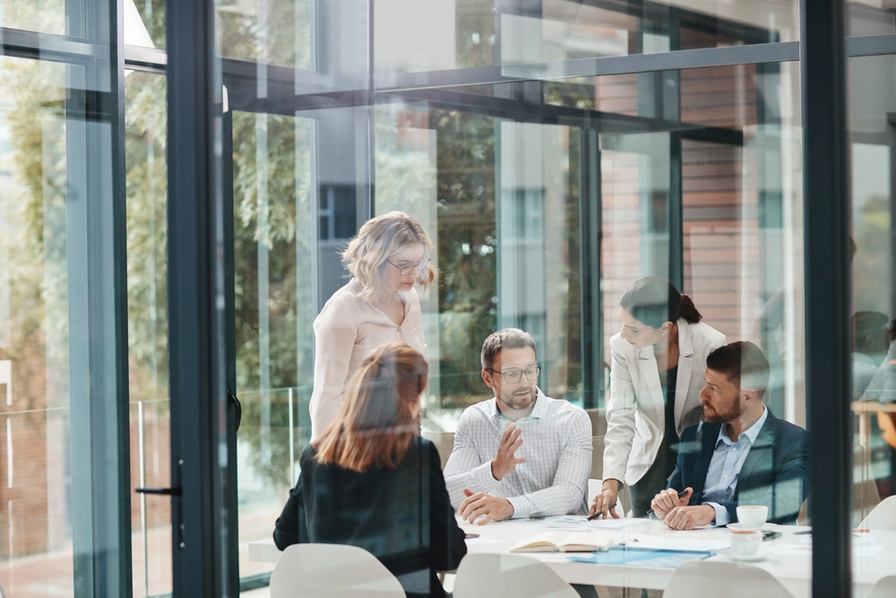 Workers in an office space with glass walls