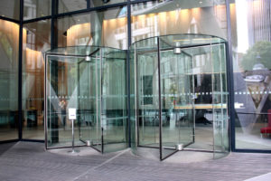 The image shows circular glass automatic doors