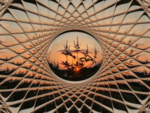 Beveled glass window with a view of the outdoors at sunset