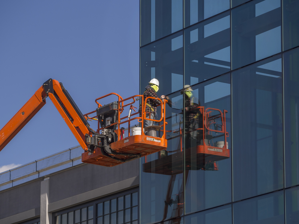 Window installer working on a commercial glass project