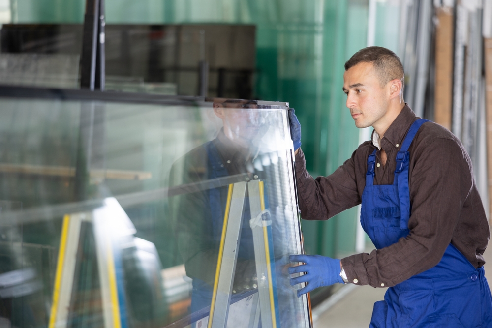 Glazier carefully moving IGUs